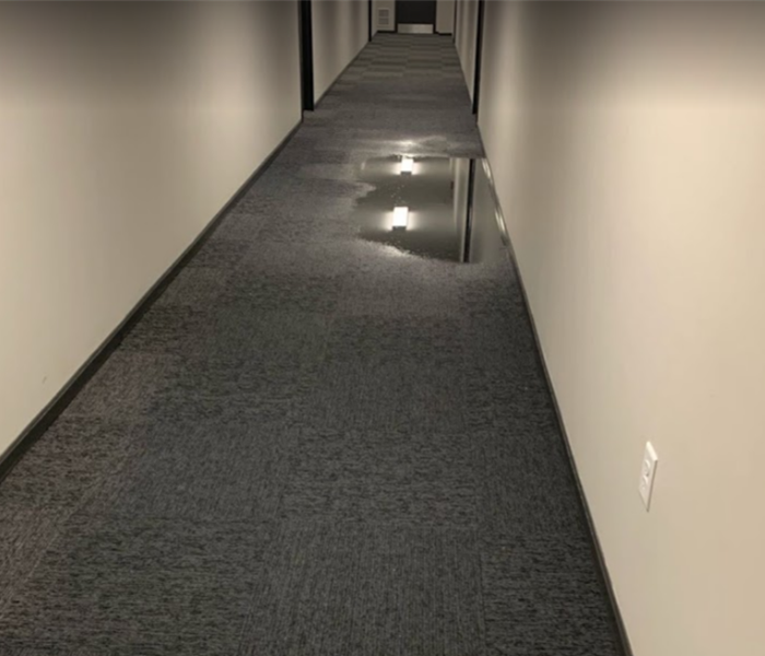 standing water in hallway of commercial building